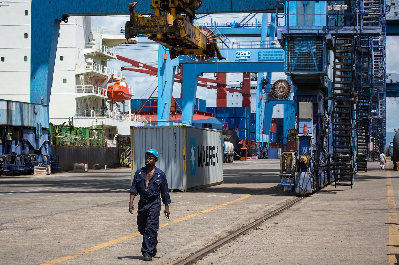 Brandmax operations team member walking through a container terminal